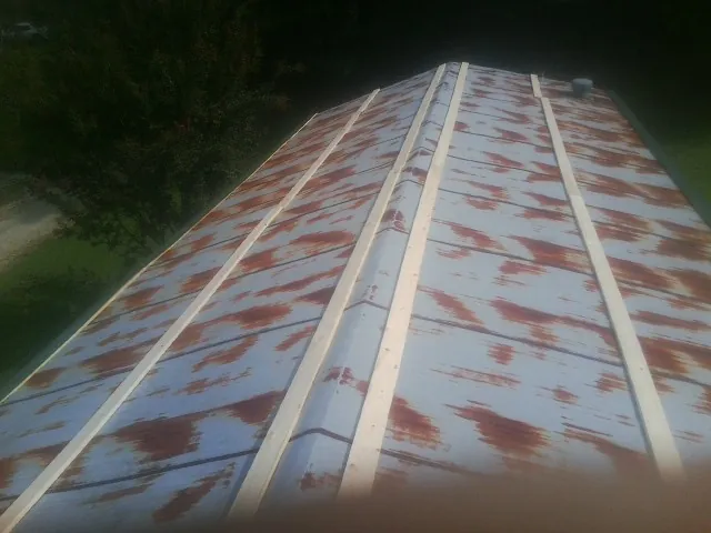 Rusted metal roof panels with new wood purlins before replacement — Storm Damage Roof Repair in Lagro by Roofing Brothers