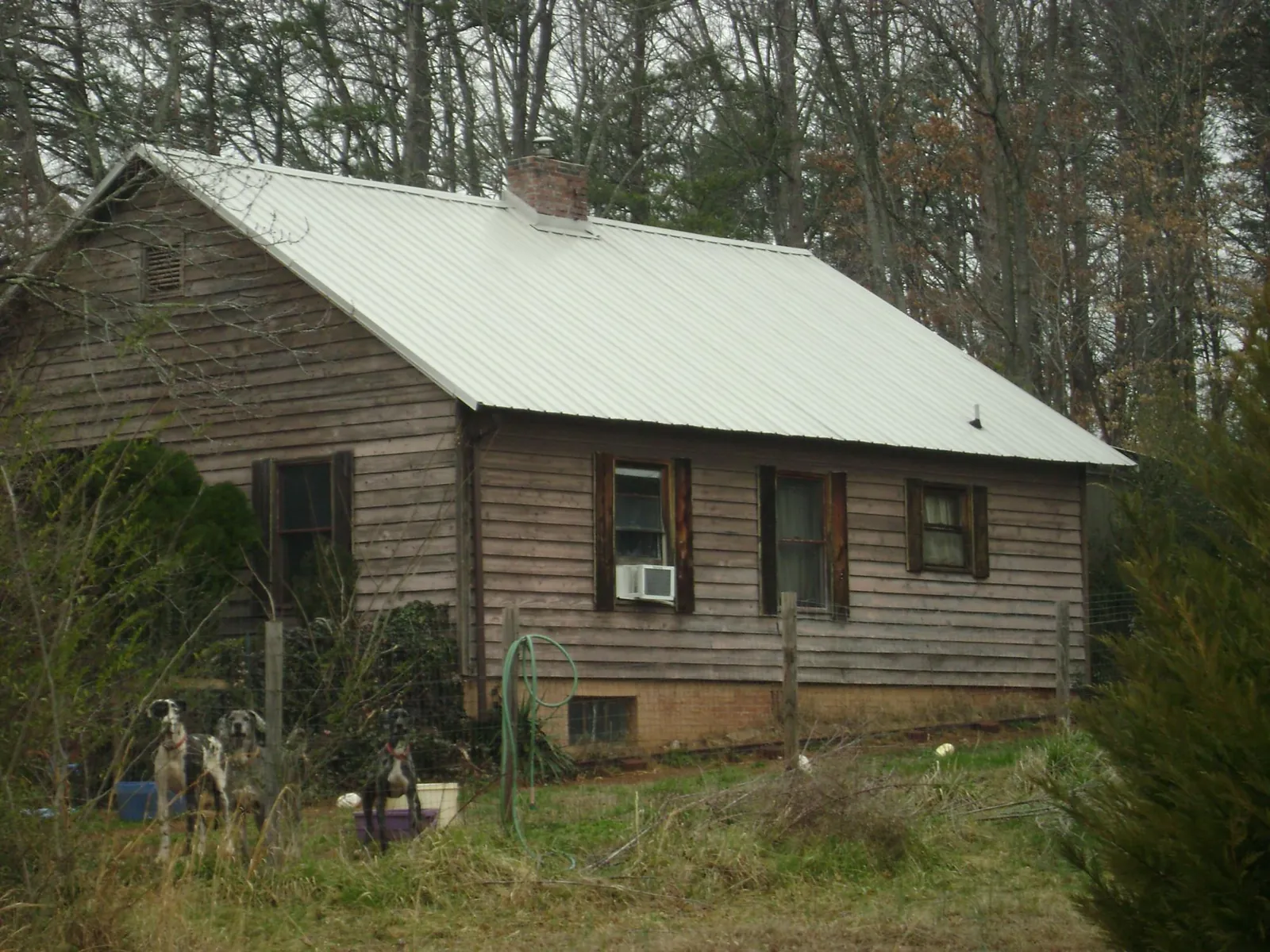White metal roof on an old wood sided farmhouse, from a Metal Roof Installation job in Lagro